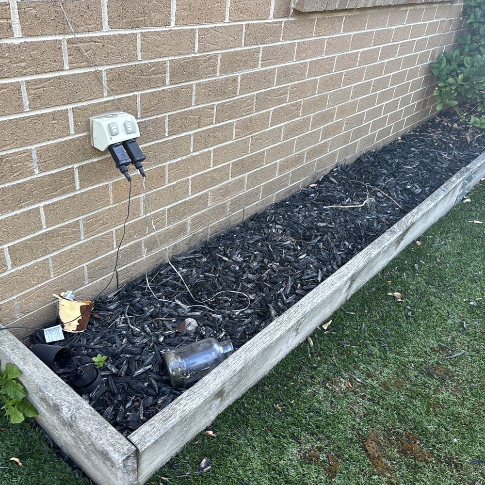 Garden bed against the wall with a tap keeping the base of the house damp, found during a building and pest inspection in Pakenham