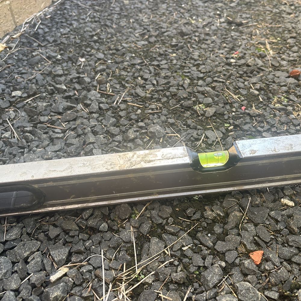 Spirit level showing the ground falling towards the wall instead of away from it, found during a building and pest inspection in Pakenham