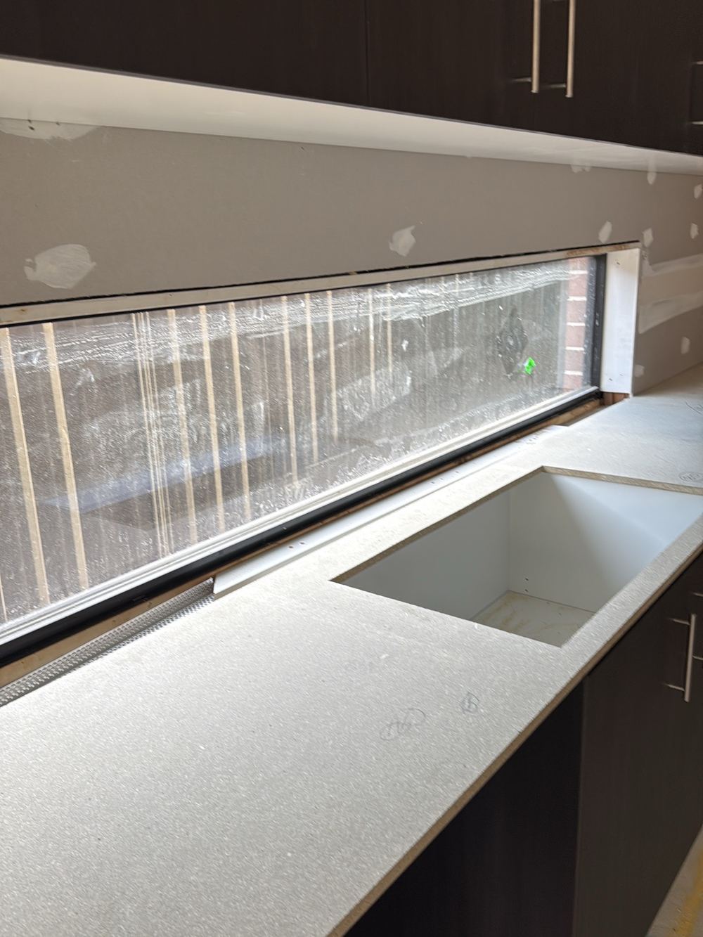 Kitchen window missing base fixings and moving when pushed, found during a fixing inspection in Pakenham