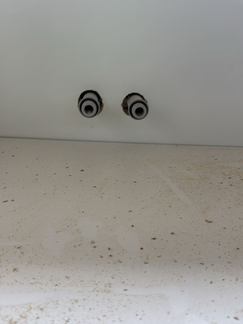 Tap penetrations in a wet area wall left unsealed, found during a fixing inspection in Pakenham
