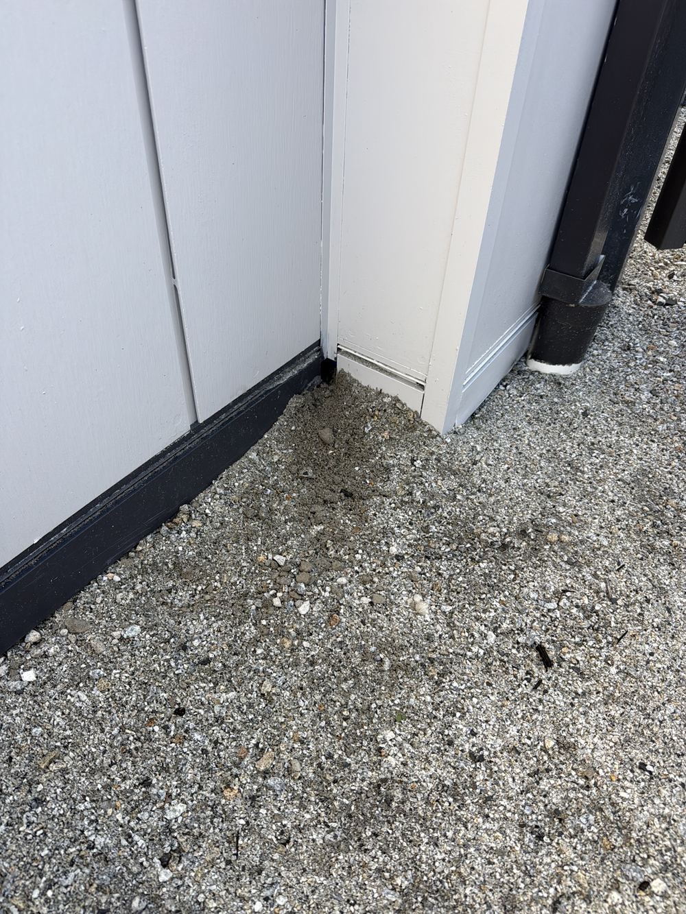 Base flashing at a cladding corner left open rather than lapped together, found during a pre-handover inspection in Pakenham
