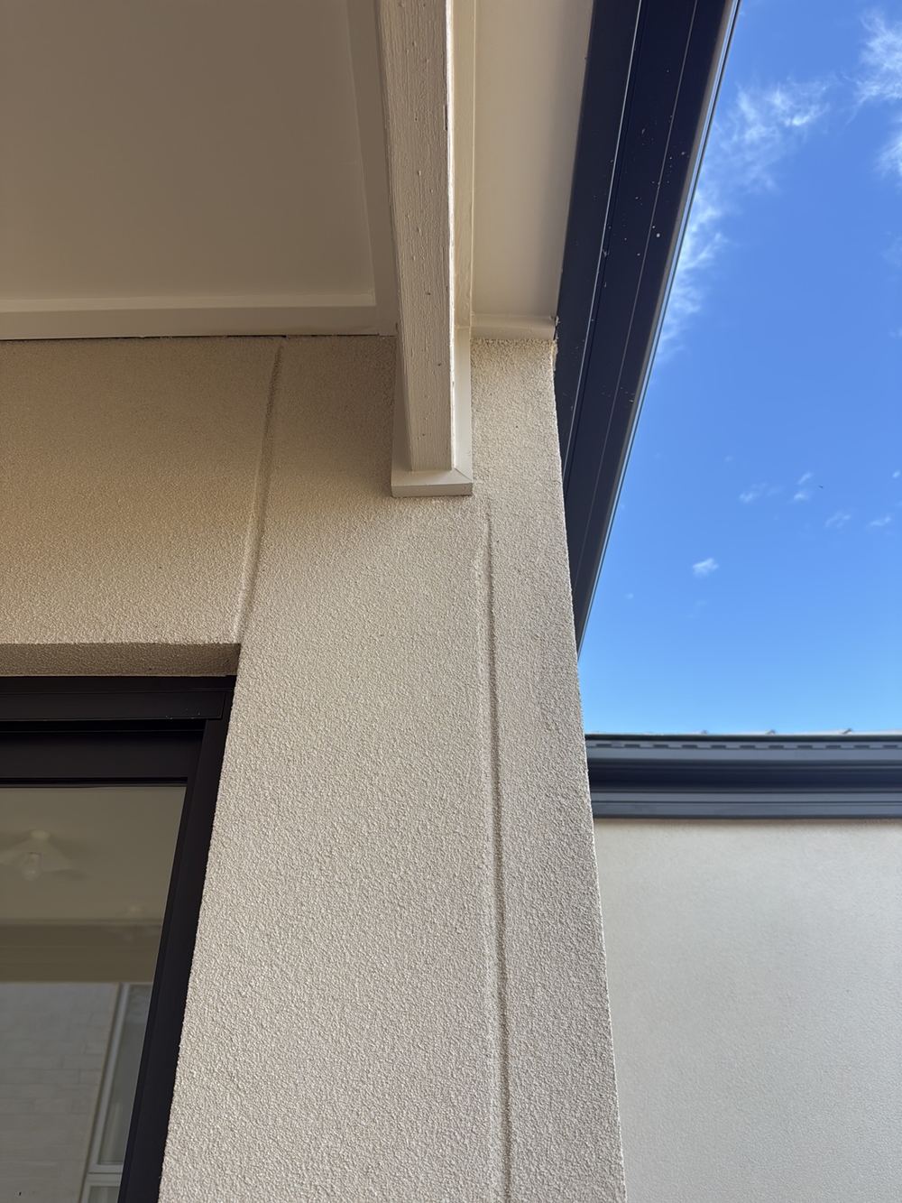 Panel cladding control joint stepping out of line beside a window, found during a pre-handover inspection in Pakenham