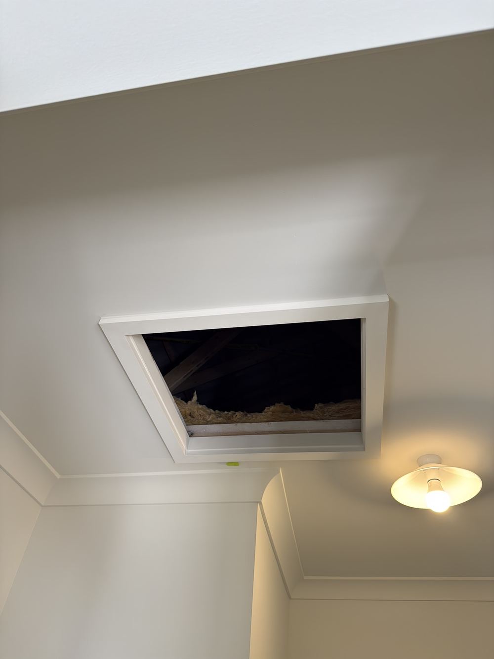 Roof space manhole left without its cover at handover, Pakenham