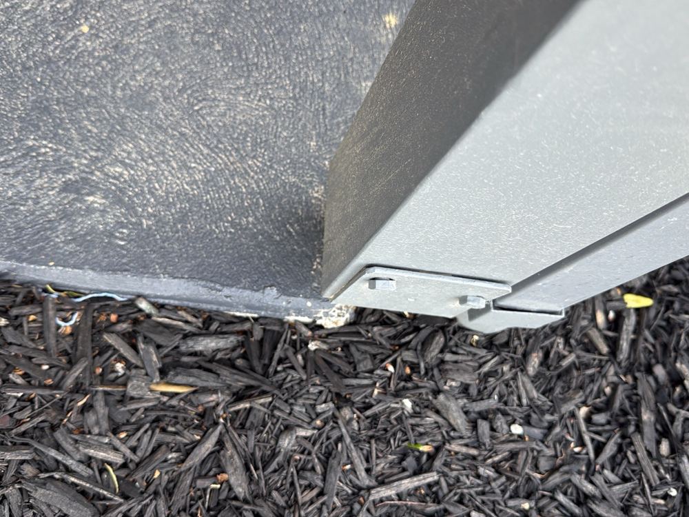 Porch post fixed to its stirrup with coach screws rather than through bolts, found during a pre-handover inspection in Pakenham