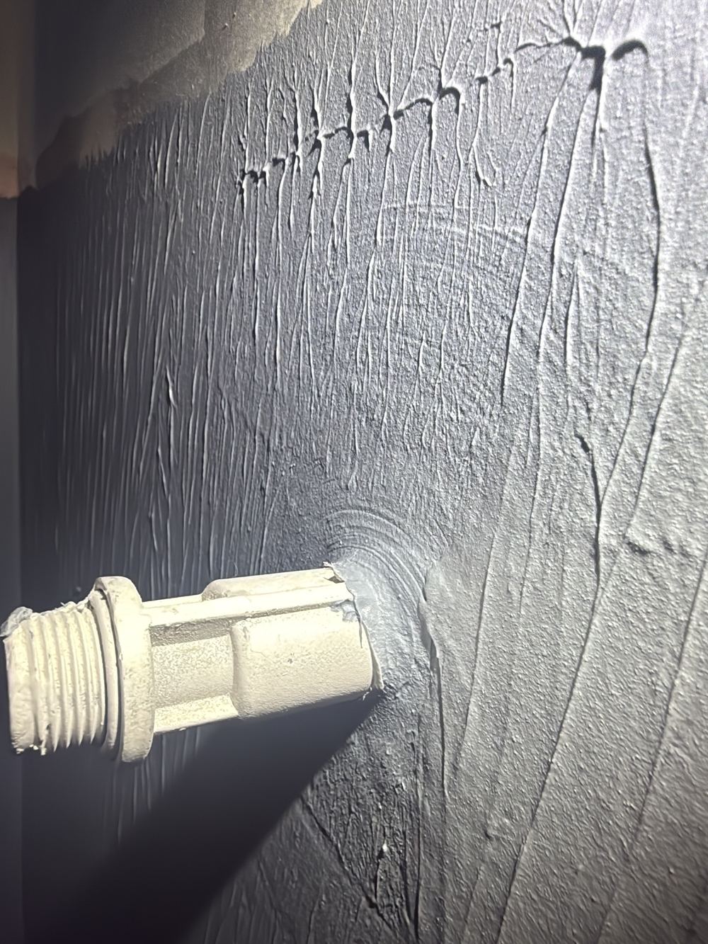 Membrane painted over the temporary plug in the shower outlet, so it will tear, found during a waterproofing inspection in Pakenham